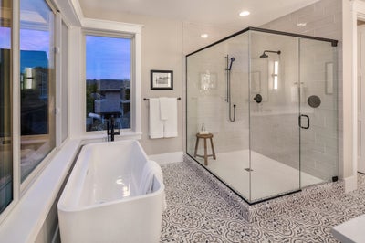 Bathroom includes tiled floor, soaking tub and large walk in shower.