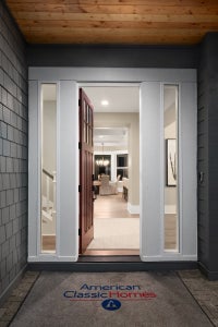 Entry way with an opened wooden door and white trim surrounding the door.