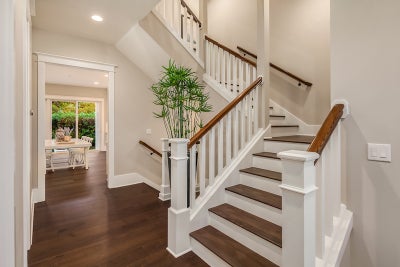 White staircase with dark wood accents.