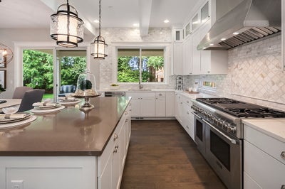 Kitchen with white cabinets and a large island