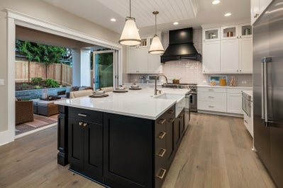 Kitchen island with black cabinets and white countertops