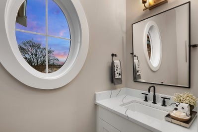 Round window next to bathroom vanity