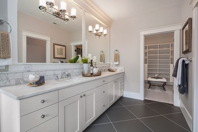 Bathroom with large white vanity and access to master closet
