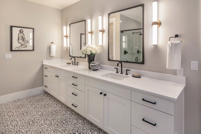 Large white vanity with double sinks and black matte finishes