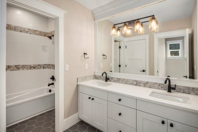 Double sink vanity with closed off bathtub