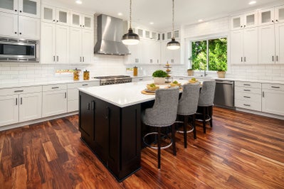 Large kitchen with white cabinets and an island