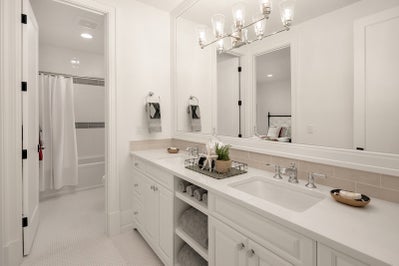 White double sink vanity with large mirror.