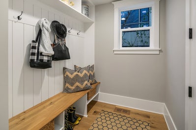 Mudroom with built in coatrack and bench.
