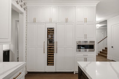 Floor to ceiling cabinets with microwave and wine fridge