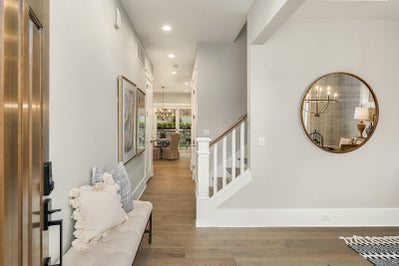 Entryway leads to formal dinning space, view of hallway with staircase leading back to breakfast nook and kitchen.