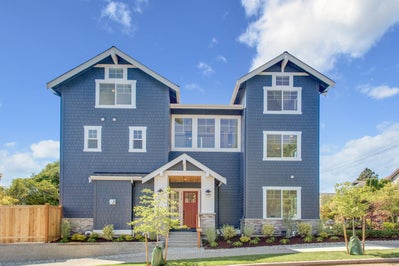 Large blue house with red door and white trim