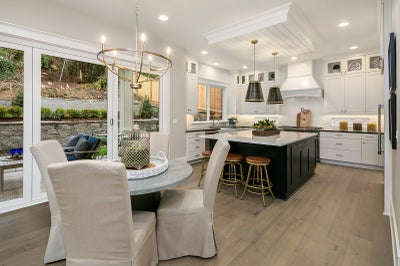 Breakfast nook open to kitchen with access to backyard