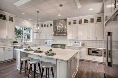 Kitchen with white cabinets and white stone countertops