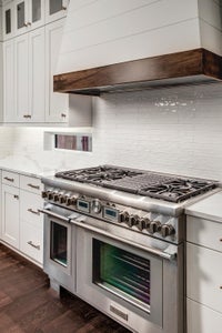 Double oven with gas range and shiplap hood