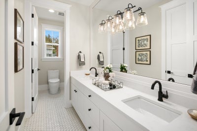 White duel sink vanity with matte black finishes.