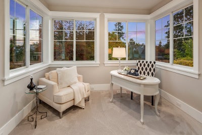 Sitting and or office space in master bedroom surrounded by windows.