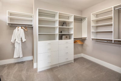 Large master closet with wood built in shelving.