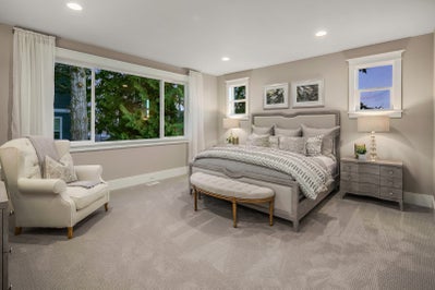 Master bedroom with multiple windows and space for a sitting area.