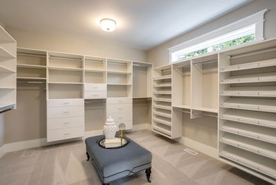 Large master closet with wood built in shelving.